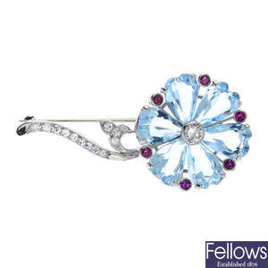An aquamarine, diamond and ruby flower brooch.