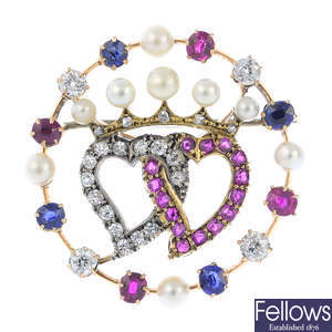 A late Victorian or early 20th century gold sapphire, ruby, pearl and diamond hearts brooch.