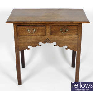 An antique oak bureau, a 19th century lowboy, and a Victorian mahogany drop leaf occasional table.