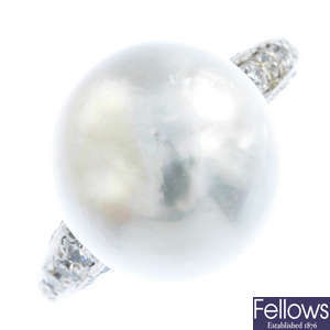 A platinum natural pearl and diamond ring.