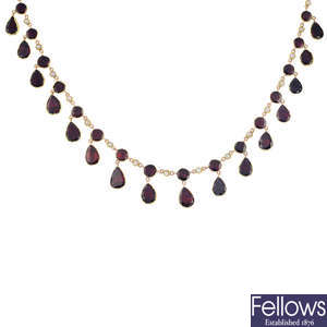 A gold foil-back garnet and split pearl necklace.