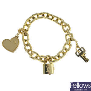 LOUIS VUITTON - an 18ct gold charm bracelet.