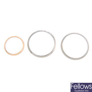 ROLEX - a group of three assorted bezels. 