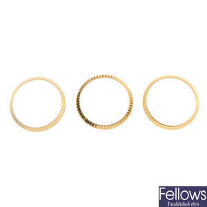 ROLEX - a group of three assorted lady's yellow metal bezels. 
