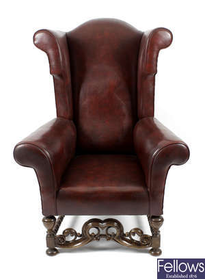 A large wingback armchair, together with a 19th century rosewood pole screen.