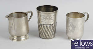 Three 20th century silver mugs & a Victorian silver beaker.