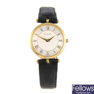 GUCCI - a mid-size gold plated wrist watch with two Gucci wrist watches.