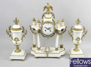 An early 20th century French gilt metal and white marble clock garniture.