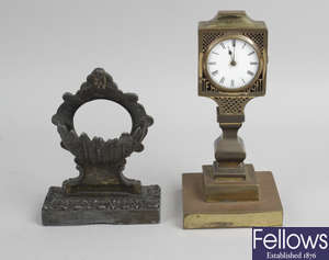 A 19th century brass cased desk clock, together with a 19th century cast metal pocket watch stand.
