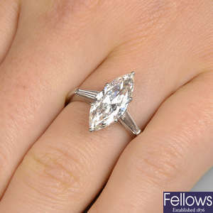 A marquise-shape diamond single-stone ring, with tapered baguette-cut diamond shoulders.