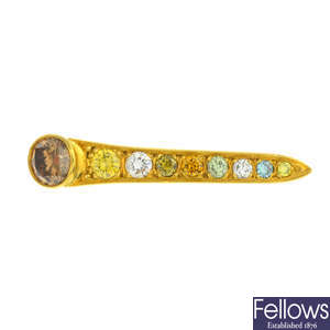 An 18ct gold coloured diamond and diamond nail brooch.