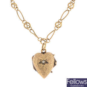 An early 20th century 18ct gold heart pendant, on a 9ct gold chain.