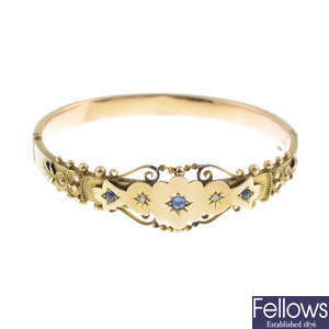An Edwardian 9ct gold paste and diamond hinged bangle.