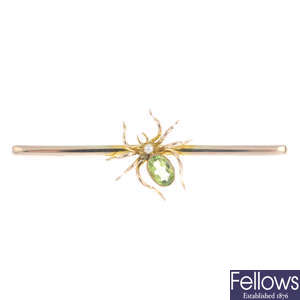 An early 20th century 9ct gold peridot and seed pearl spider bar brooch.