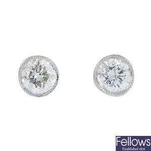 A pair of brilliant-cut diamond collet stud earrings.