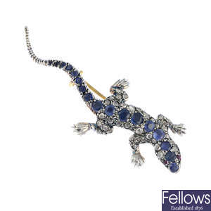 A sapphire and diamond lizard brooch.