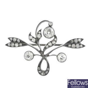 An Art Nouveau silver and gold diamond floral brooch.