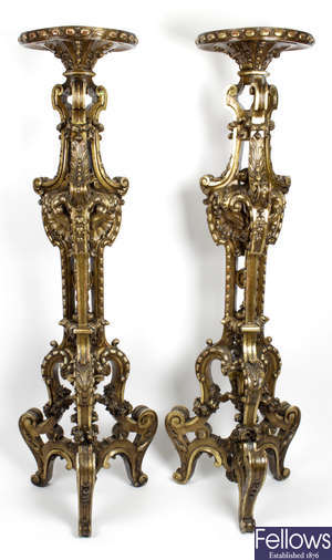 A pair of 20th century carved gilt wooden torchere stands.