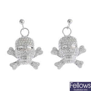 A pair of diamond skull and crossbone earrings.