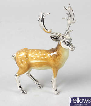 A modern silver and enamel ornament of a fallow deer stag.