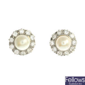 A pair of cultured pearl and diamond stud earrings.