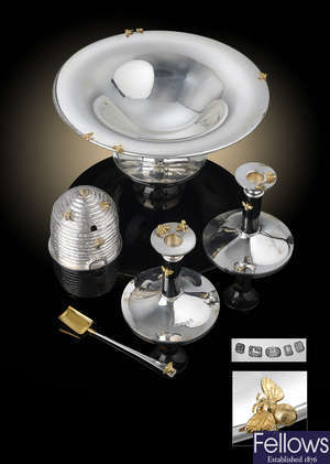 An impressive cased silver set by Theo Fennell, comprising honey pot, pair of candlesticks and footed dish.