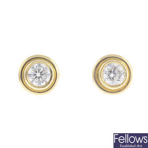 A pair of brilliant-cut diamond single-stone stud earrings.