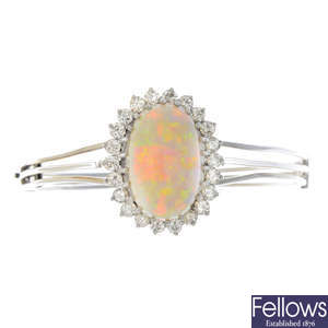 An opal and diamond cluster hinged bangle.