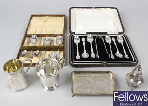 Two silver christening cups, two cased sets of teaspoons, a silver pepper pot & a small dish.