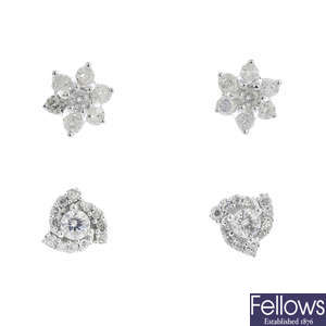 Two pairs of diamond earrings.