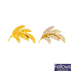 Two coloured diamond leaf brooches.