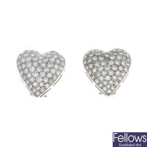 A pair of diamond heart earrings.