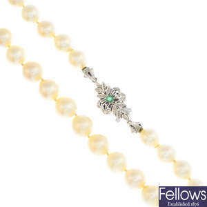 A cultured pearl single-strand necklace, with emerald clasp.