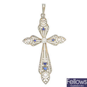 A sapphire and diamond cross pendant.