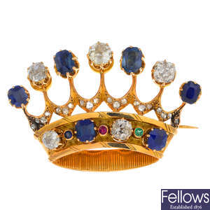 A mid 20th century gold sapphire, diamond, emerald and ruby crown brooch.