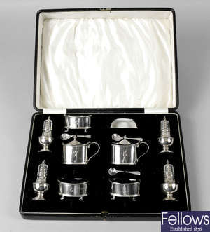 Three cased 1920's & 1930's silver part condiment sets.