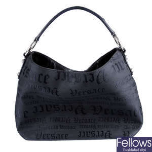 VERSACE - a black canvas handbag.