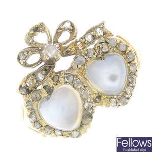 An early 20th century moonstone and diamond twin heart ring.