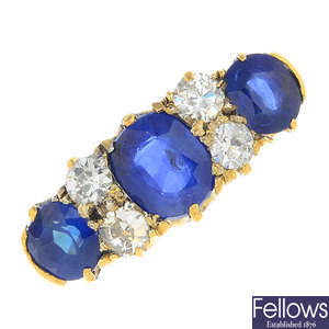 An early 20th century 18ct gold sapphire three-stone and diamond ring.