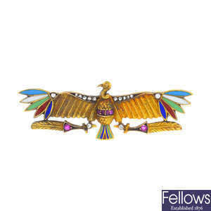 An Egyptian revival diamond, ruby and enamel bird brooch.