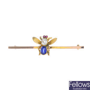 An early 20th century gold diamond, sapphire and ruby fly brooch.