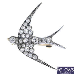 A late Victorian silver and gold diamond swallow brooch.