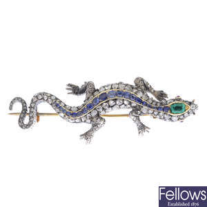 An early 20th century silver and gold, diamond, emerald, sapphire and ruby lizard brooch.