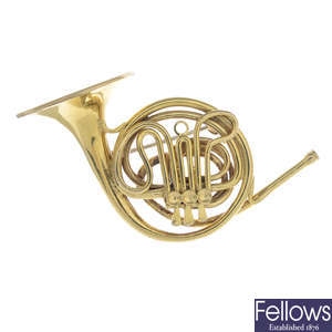 CARTIER - a French Horn brooch.