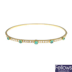 An emerald and diamond hinged bangle.
