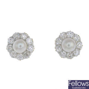 A pair of natural pearl and diamond cluster earrings.