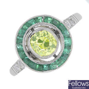 A 'greenish yellow' diamond, diamond and emerald cluster ring.