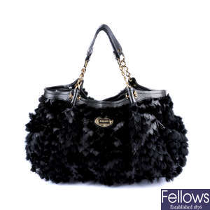 VERSACE - a black fur and leather handbag.
