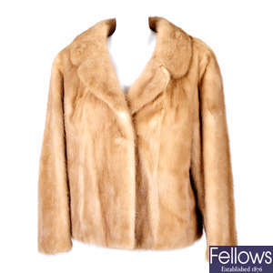 A pastel mink jacket and two mink stoles.