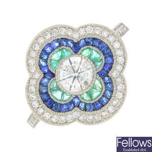 A diamond, emerald and sapphire ring.